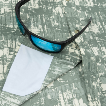 Closeup of sunglasses with lens cleaner on shirt