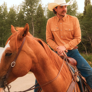 man on horse wearing the clyde long sleeve pearl snap shirt