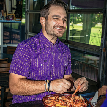 Man eating wearing death valley shirt