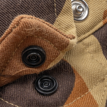 Close-up of durable snap buttons and textured fabric detail on The Delta Cowboy shirt in an outdoors-inspired pattern.