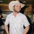 man wearing cowboy hat and the diamond back shirt