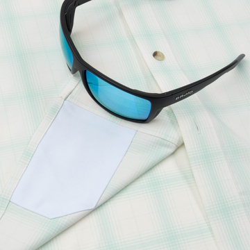 sunglasses with lens cleaner on shirt