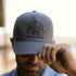 man wearing the grey eagle trucker hat