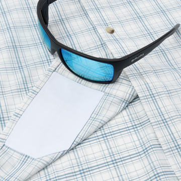 Closeup of sunglasses with lens cleaner on shirt
