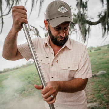 Man cooking crawfish while wearing the Gumbo shirt