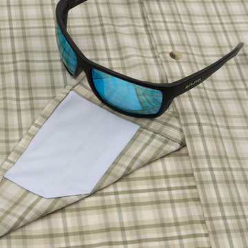 Closeup of sunglasses with lens cleaner on shirt