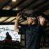 Man adjusts his Protective mask while wearing The Farrier Shirt