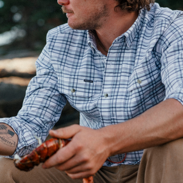 The Fog Horn plaid shirt worn outdoors while holding grilled food