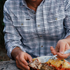 The Fog Horn blue plaid shirt worn while enjoying a meal outdoors