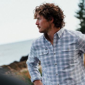 The Fog Horn plaid shirt worn by a man outdoors near the coast