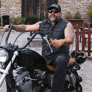 Man riding a motorcycle while wearing The Full Throttle Shirt