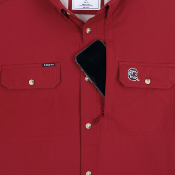 Red shirt "The Gamecock" with button pockets and a phone tucked inside the chest pocket