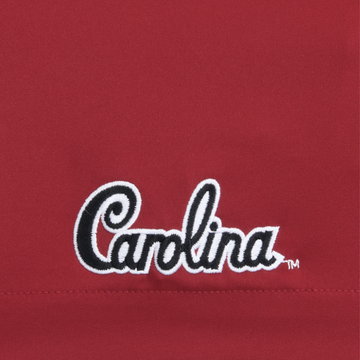 Close-up of red fabric with black and white embroidered Carolina text on The Gamecock shirt