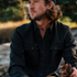 The Gloucester dark plaid shirt worn outdoors by a man beside a woodland stream