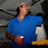 The Grandstand blue button up shirt worn by a smiling man serving food at an outdoor gathering