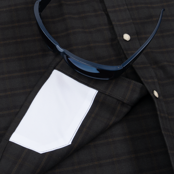 Closeup of sunglasses with lens cleaner on shirt