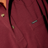 Close-up of a burgundy shirt with button details and a small Poncho label, part of The Gridiron collection.
