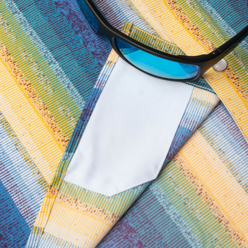 sunglasses with lens cleaner on shirt