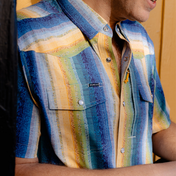 man wearing the gris gris striped shirt