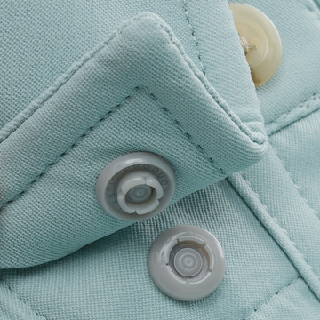 Close-up of light blue fabric with detailed stitching and snap buttons on The Gulf Stream shirt.
