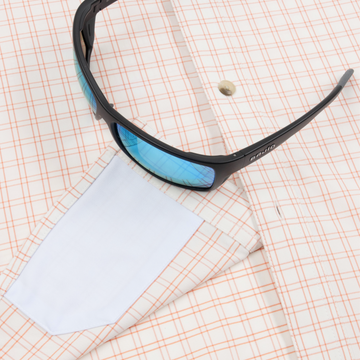 Closeup of sunglasses with lens cleaner on shirt
