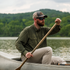 The Gunnison olive green mens outdoor shirt worn while paddling a canoe on a lake