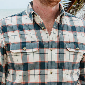 The Half Moon plaid button up shirt with chest pockets worn outdoors