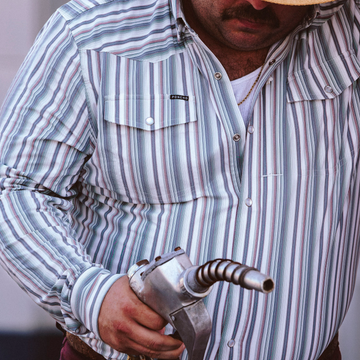 The Hammer Down striped shirt worn while holding a vintage fuel nozzle