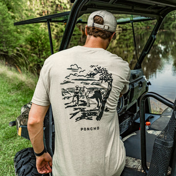 man Wearing headed west tee getting in utv