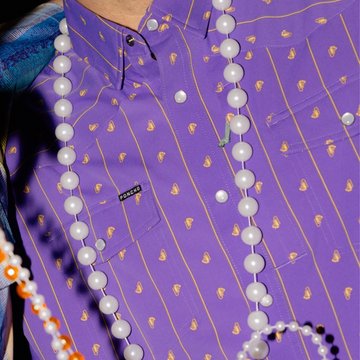 man with beads wearing the hoodoo shirt