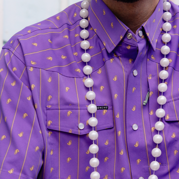 man wearing beads and the hoodoo shirt