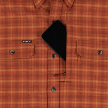 The Hot Sauce orange plaid shirt with buttoned chest pockets and a black triangular detail