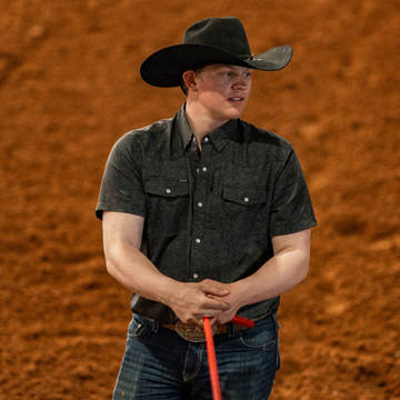 man wearing the john coffee holding a rope