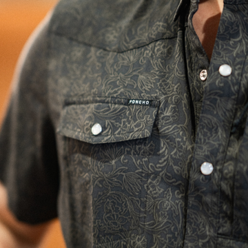 closeup of man wearing the john coffee shirt