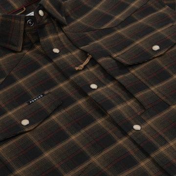 Close-up of The John Colter plaid button-up shirt in brown and black tones with snap closures and chest pockets