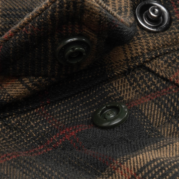 Close-up of button details on The John Colter outdoors shirt in brown plaid fabric