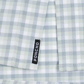 The Kawakawa plaid shirt fabric with woven Poncho label in soft green and white checks