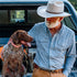 Man wearing the lariat blue long sleeve shirt with dog