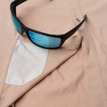 Closeup of sunglasses with lens cleaner on shirt