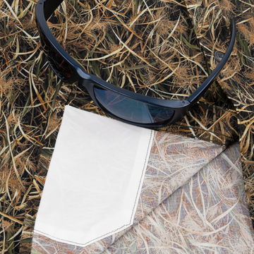 Closeup of sunglasses with lens cleaner on shirt