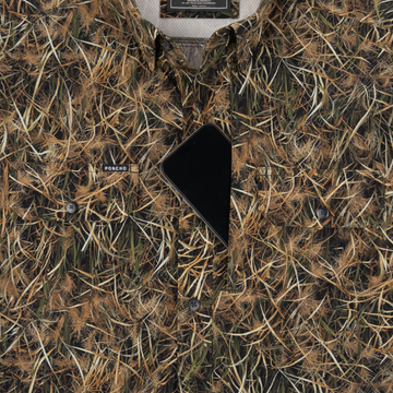 Phone in chest zipper pocket of shirt