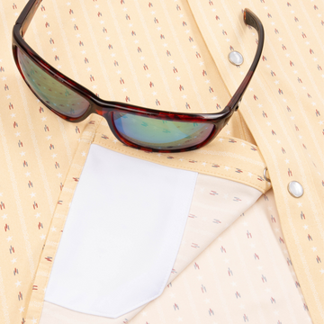 Closeup of sunglasses with lens cleaner on shirt