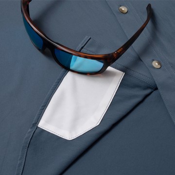 Close-up of The Little Tuna shirt pocket with sunglasses resting on it