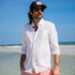 man on beach wearing the live well