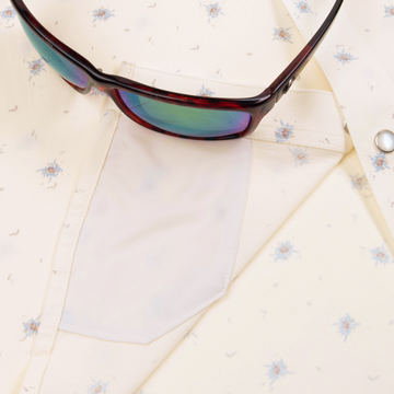 Closeup of sunglasses with lens cleaner on shirt