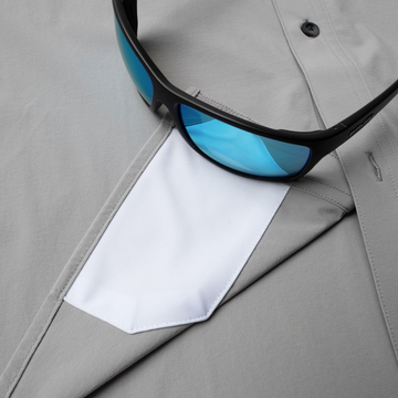 sunglasses with lens cleaner on shirt