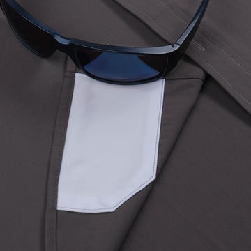 Close-up of a pocket detail on The Lug Nut shirt with black sunglasses resting on top