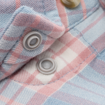Close-up of button snaps on The Madaket shirt featuring soft pastel blue and pink plaid fabric.