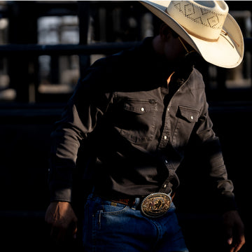 The Matamoros black button-up shirt worn with jeans and a cowboy hat