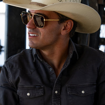 The Matamoros black shirt styled with a wide brim hat and tinted sunglasses outdoors